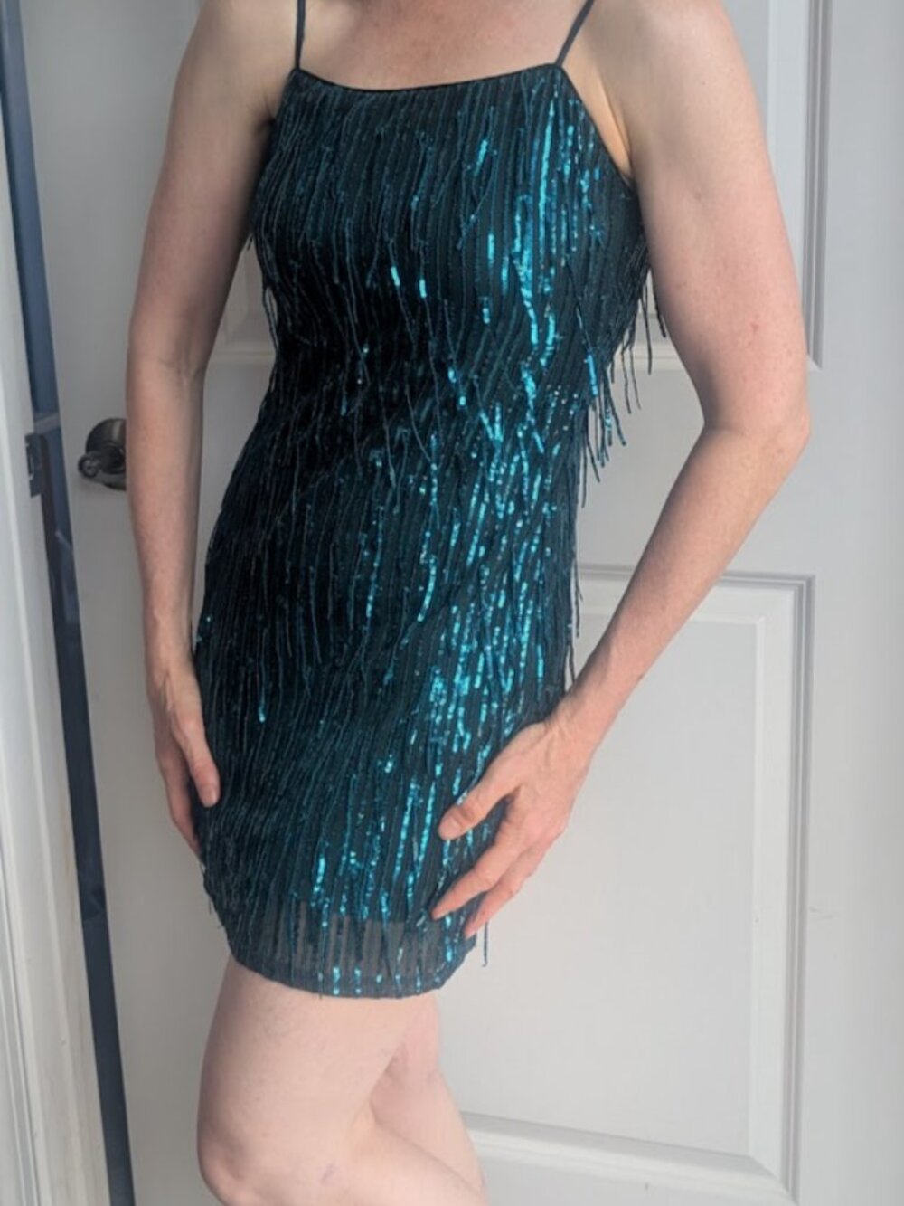 Sparkly sequined green party dress with fringe accents.